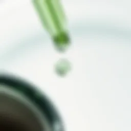 A close-up of green serum droplets on a glass surface