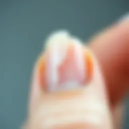A close-up of a broken nail showcasing the fracture